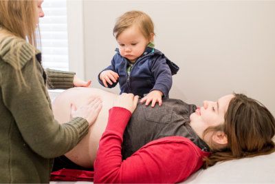 Amy Garrison, CNM with patient